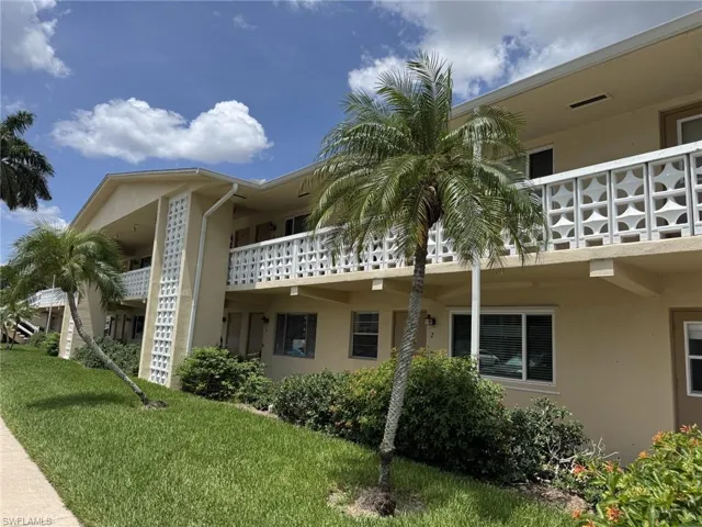 Notice the new hurricane impact windows and the front door to the living room and a second front door to the kitchen. The front of the building has a beautiful art deco vibe.