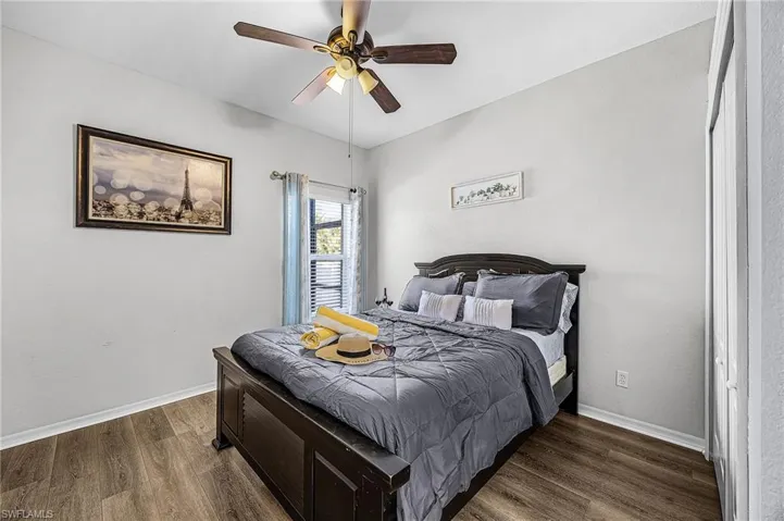 Bedroom with dark wood finished floors and ceiling fan