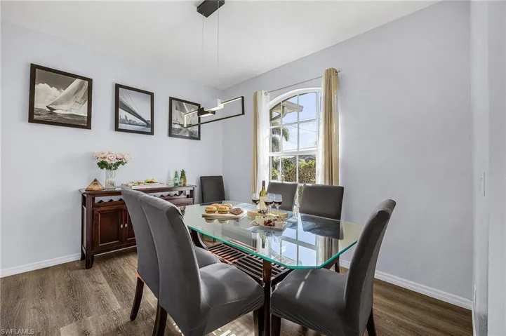 Dining room featuring dark wood finished floors and baseboards