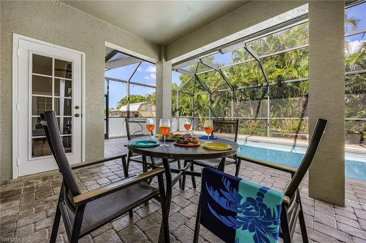 View of patio featuring glass enclosure and a sunroom