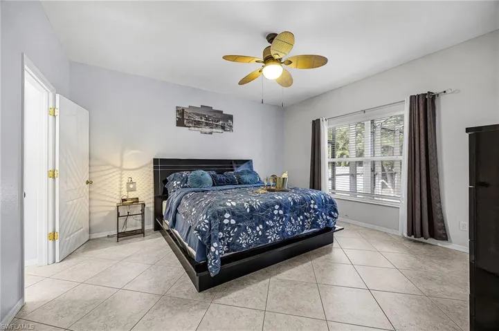 Bedroom featuring tile patterned floors and ceiling fan