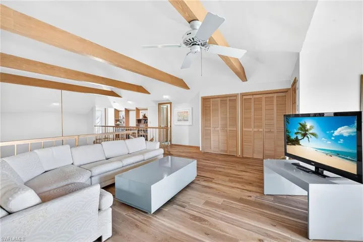 Loft with light wood finished floors and ceiling fan