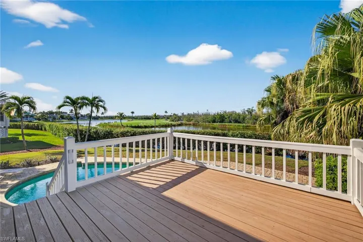 Deck featuring an outdoor pool, a water view, and a patio