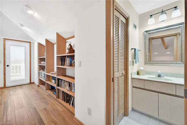 Hallway featuring a sink and light wood-style floors