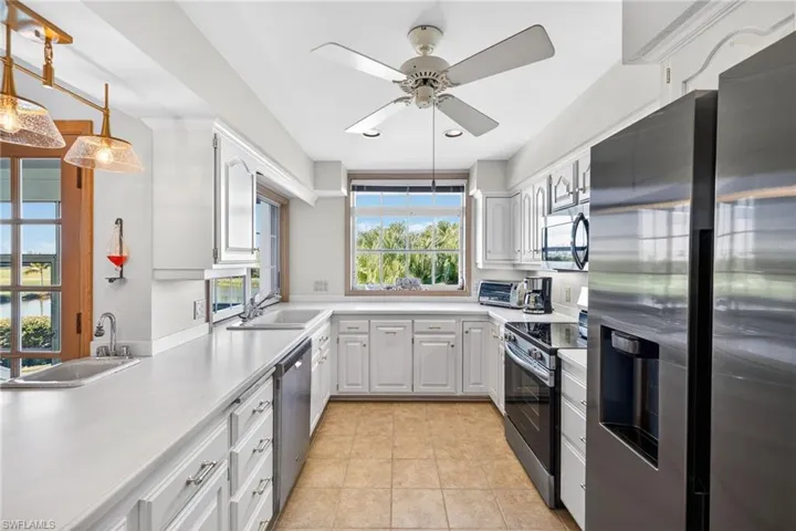Kitchen featuring appliances with stainless steel finishes, light countertops, white cabinets, and recessed lighting
