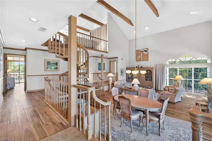 Dining area featuring recessed lighting, a wainscoted wall, wood finished floors, stairway, and a ceiling fan