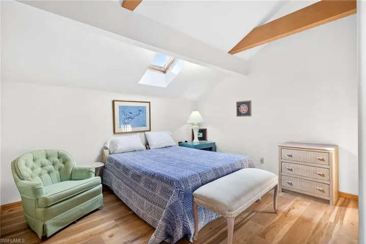 Bedroom featuring a skylight and light wood finished floors