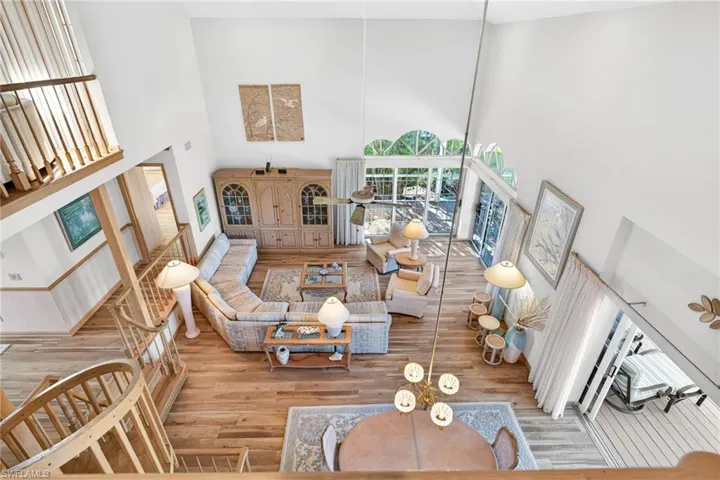 Living area featuring a towering ceiling and wood finished floors