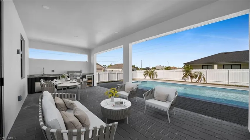 Fenced backyard featuring area for grilling, a patio area, outdoor dining space, an outdoor living space, and beverage cooler