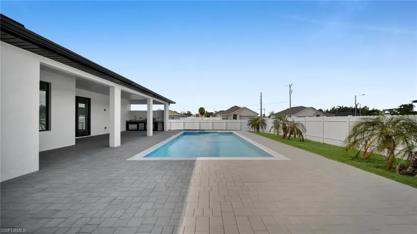 View of pool with a patio area and a fenced backyard