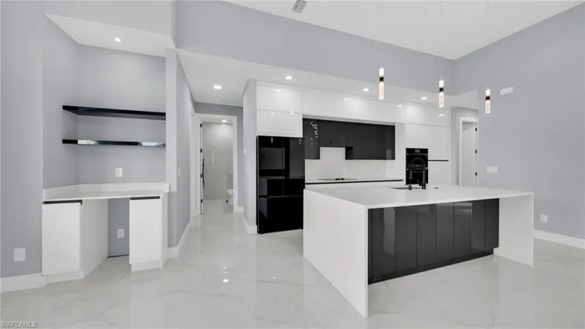 Kitchen with modern cabinets, pendant lighting, black appliances, open shelves, and white cabinets
