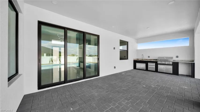 View of patio with exterior kitchen and a sink