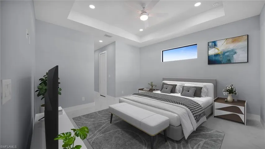 Bedroom featuring a raised ceiling, recessed lighting, and a ceiling fan