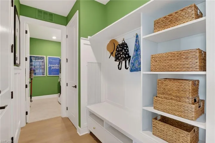 A drop zone featuring built-in shelves and a welcoming bench.