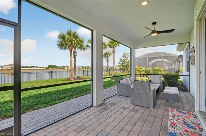 Covered Lanai featuring  ceiling fan, outdoor furniture, a water view, and healthy amount of natural light