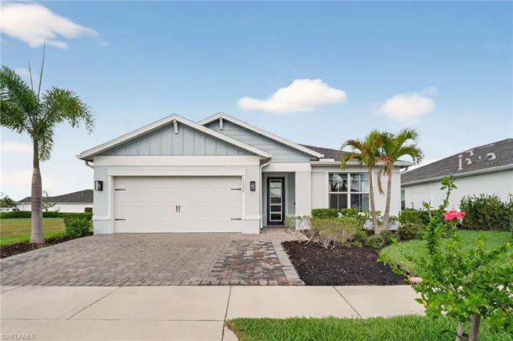 Ranch-style house with decorative driveway and a 2-car garage.