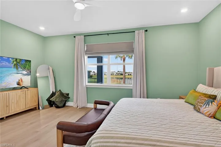 Bedroom with light wood-style flooring, recessed lighting, and ceiling fan