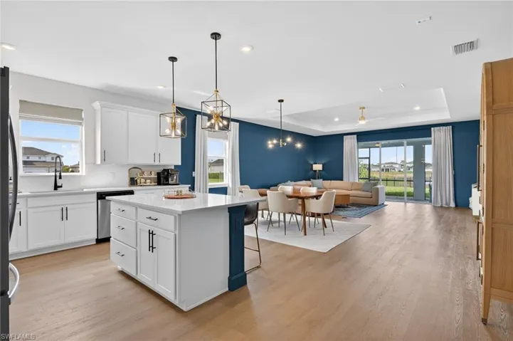 Kitchen with open floor plan, a kitchen breakfast bar, plenty of natural light