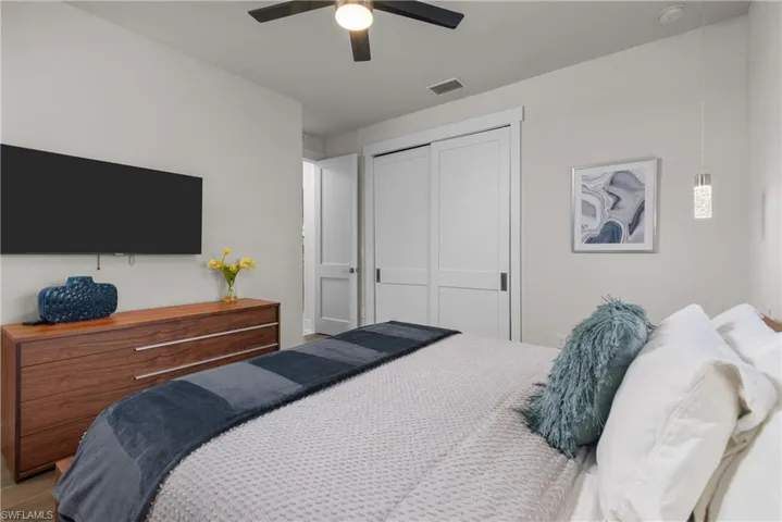 Bedroom with a closet, a ceiling fan, and wood finished floors