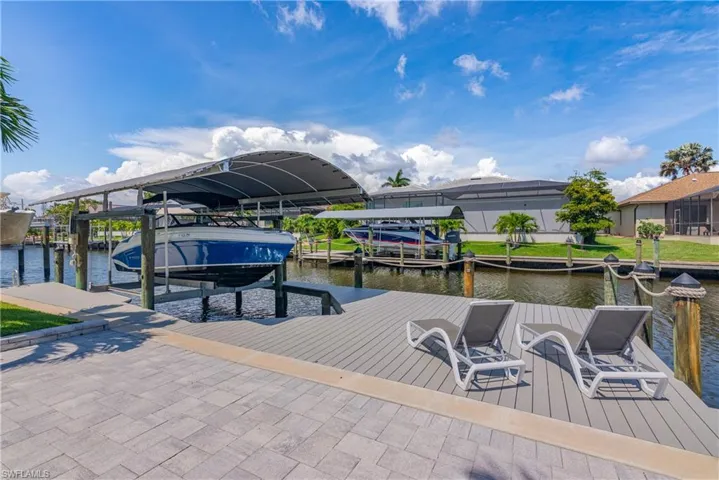 Dock area with boat lift and a water view