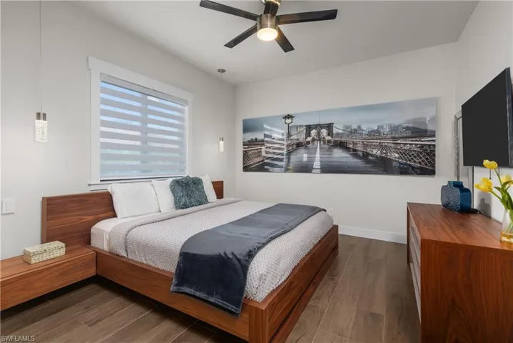 Bedroom featuring wood finished floors, ceiling fan, and baseboards