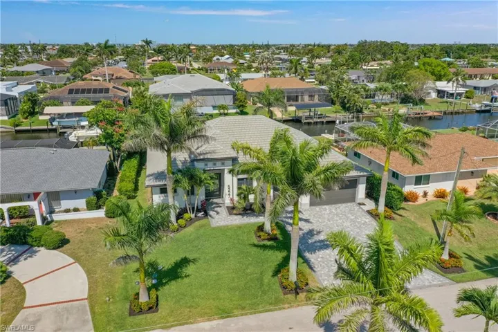Aerial perspective of suburban area with a nearby body of water