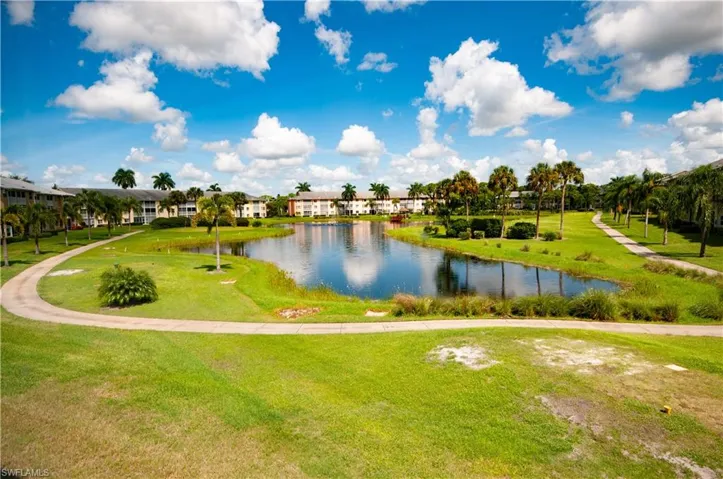 View of property's community featuring a yard and a water view