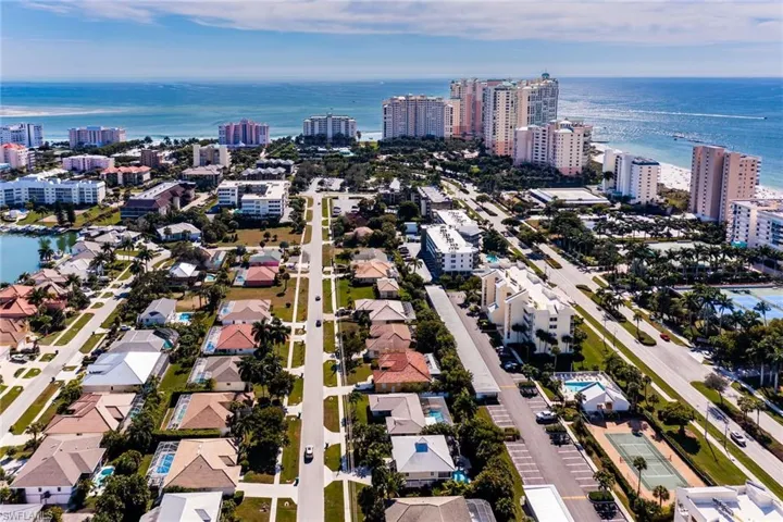 Aerial view of property's location with nearby urban area and a nearby body of water