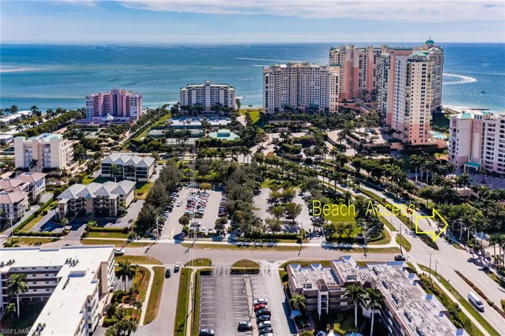 Aerial overview of property's location featuring a large body of water and nearby urban area