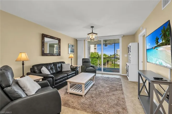 Living area with a chandelier and light tile patterned flooring