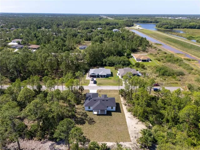 Drone / aerial view with a water view and a forest view