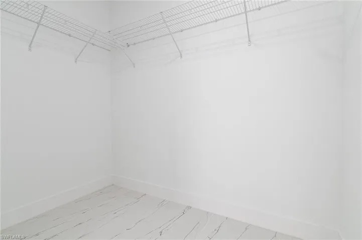 Spacious closet with marble finish floor