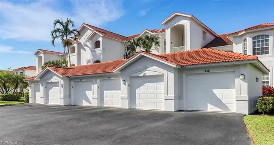 Mediterranean / spanish-style house with a tiled roof, community garages, and stucco siding