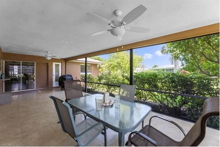 Sunroom / solarium with ceiling fan, outdoor dining space, and healthy amount of natural light
