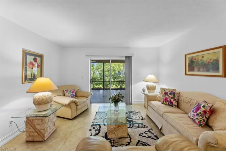 Tiled living area featuring baseboards
