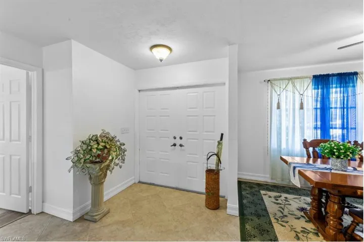 Entrance foyer with baseboards and a textured ceiling
