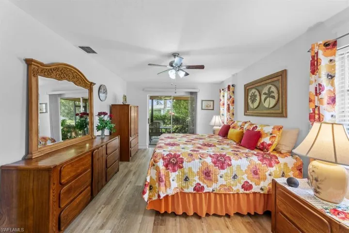 Bedroom with light wood-style floors, access to exterior, and a ceiling fan
