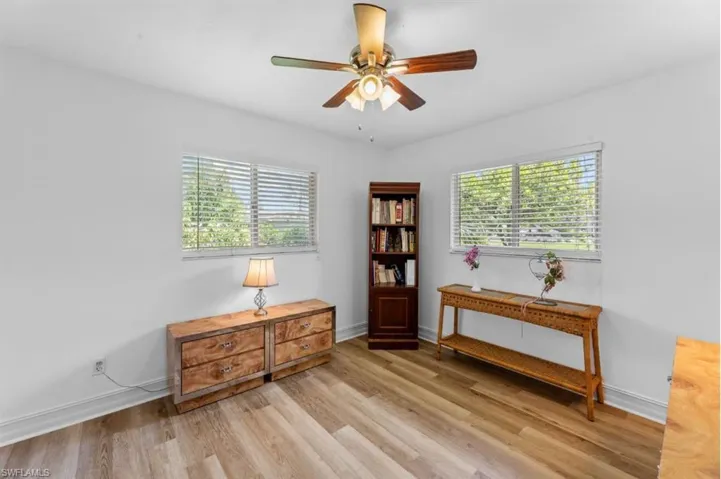 Living area with light wood-type flooring and ceiling fan