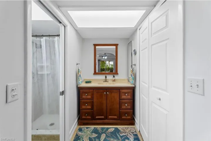 Full bath featuring vanity and a shower stall