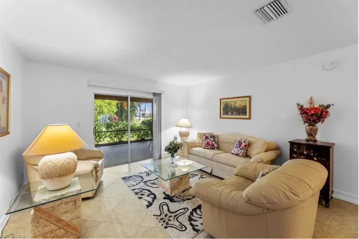 Living area with light tile patterned floors and baseboards