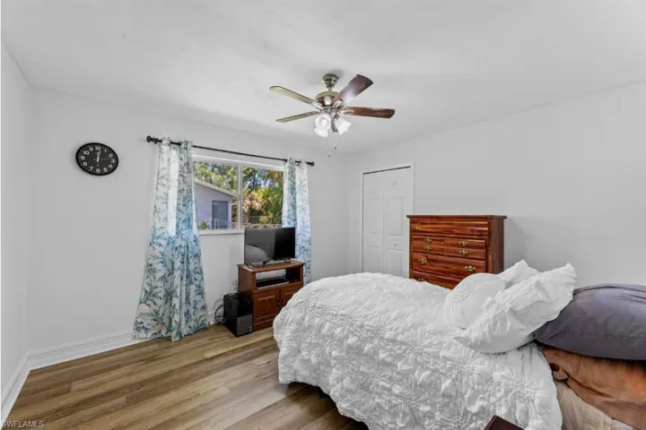 Bedroom with wood finished floors, a closet, and a ceiling fan