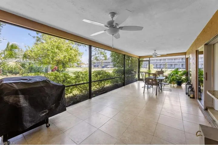 Sunroom / solarium with ceiling fan and outdoor dining space
