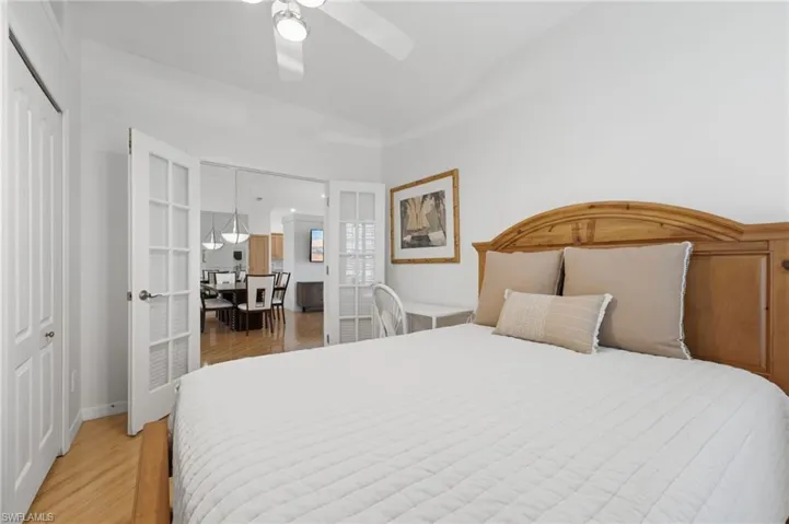 The versatile second bedroom features elegant French glass doors with Hunter Douglas blinds for privacy, beautiful plantation shutters, abundant natural light, and two closets for exceptional storage. This flexible space is ideal as a guest suite or a sophisticated home office tailored to your lifestyle needs.