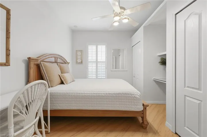 The versatile second bedroom offers beautiful plantation shutters, an abundance of natural light, and two closets for ample storage. Designed for flexibility, this inviting space can also serve as a private home office or dedicated workspace to suit your lifestyle needs.