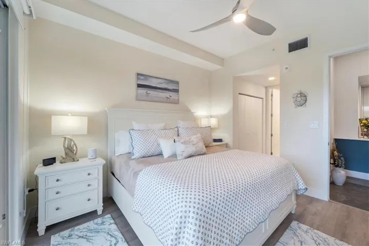 Bedroom featuring baseboards, visible vents, a ceiling fan, dark wood-type flooring, and a closet