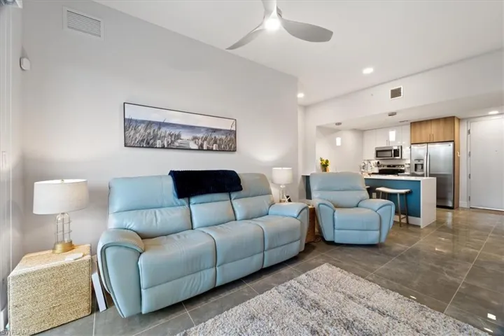 Living room featuring ceiling fan, visible vents, and recessed lighting