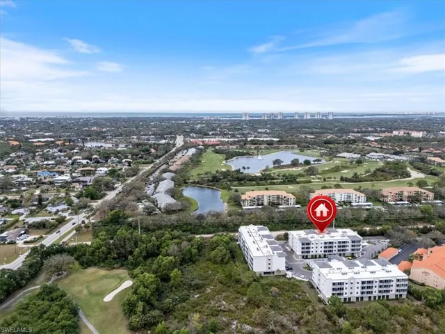 Aerial view featuring a water view and a view of city