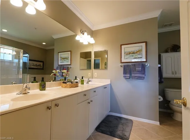 Full bath with double vanity, a shower stall
