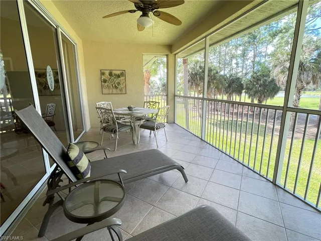 Sunroom / solarium featuring a ceiling fan and outdoor dining area