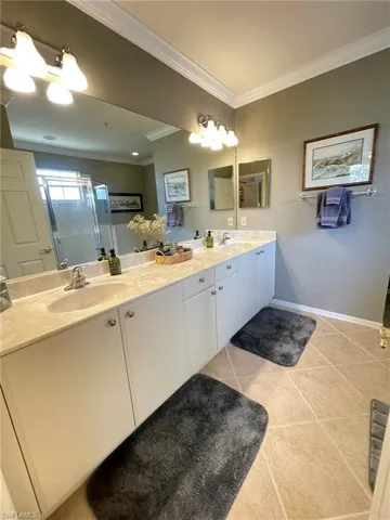 Full bath with double vanity, a shower stall
